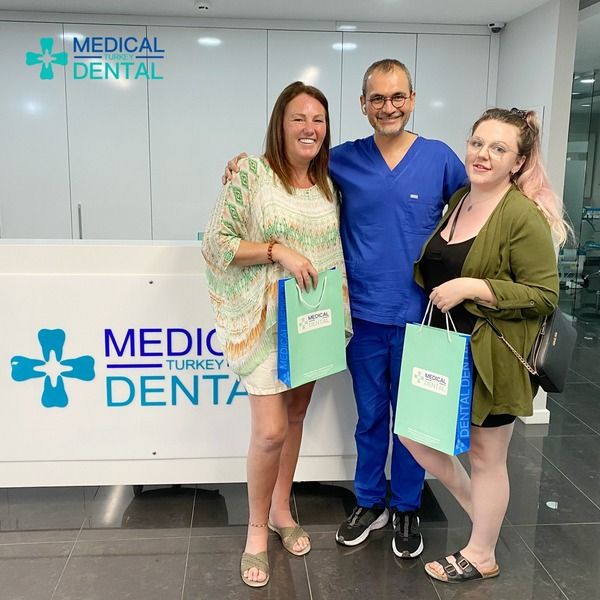 Dt.Selhan had a photo with the patients who had full mouth implant in Turkey