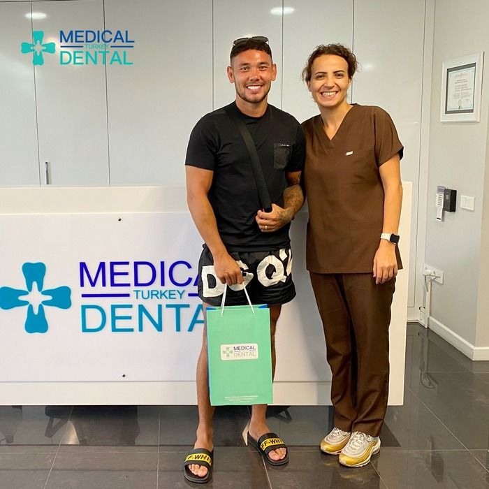 women dentist give pose with a patient who had laminate veneers in turkey